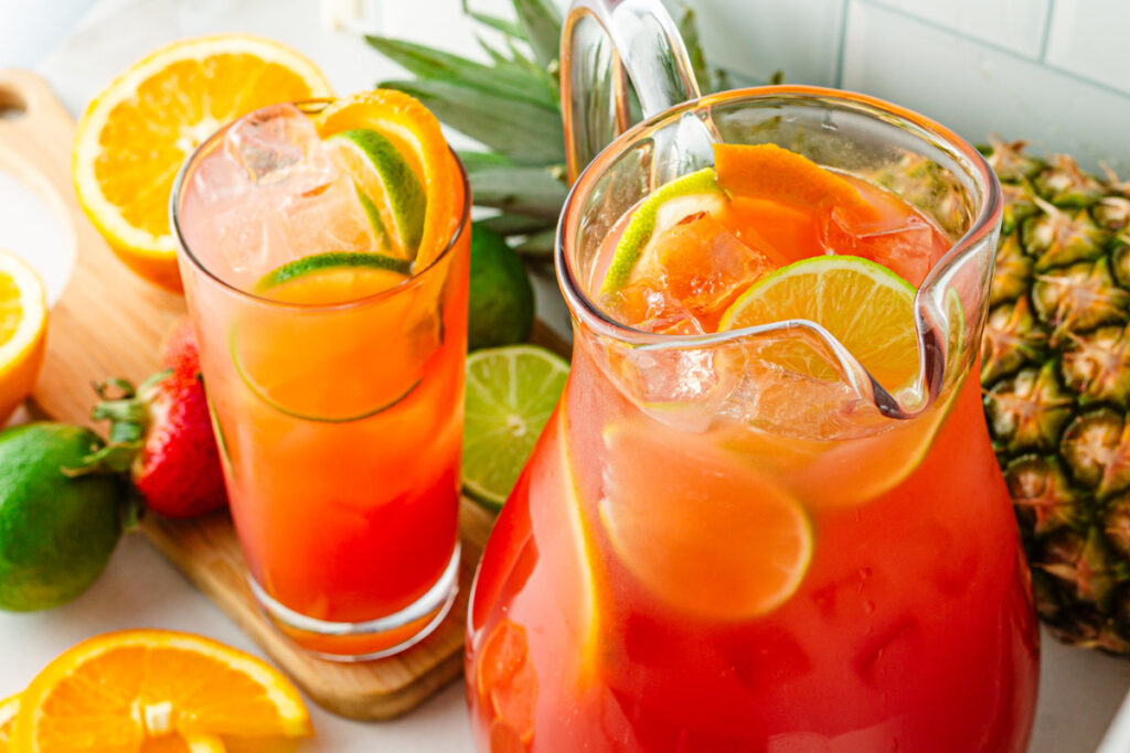 glass of tropical fruit punch with citrus slices 