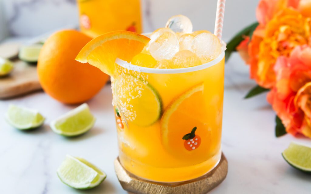glass of tropical passionfruit mocktail with flowers