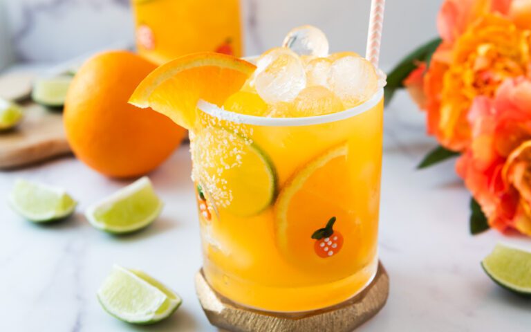 glass of tropical passionfruit mocktail with flowers