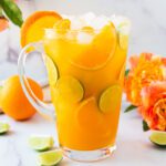 pitcher of Passionfruit Tropical Virgin Margarita Mocktail with fresh citrus and flowers