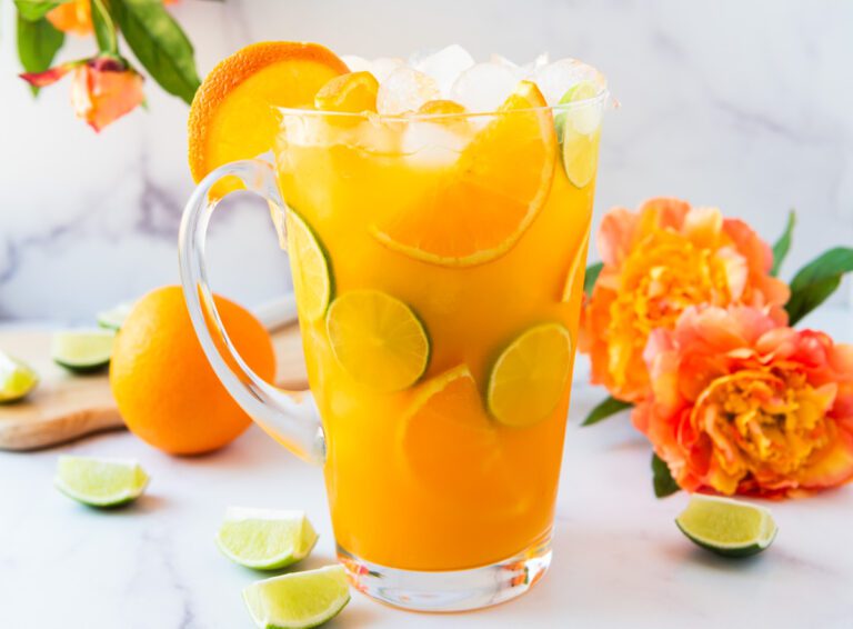 pitcher of Passionfruit Tropical Virgin Margarita Mocktail with fresh citrus and flowers