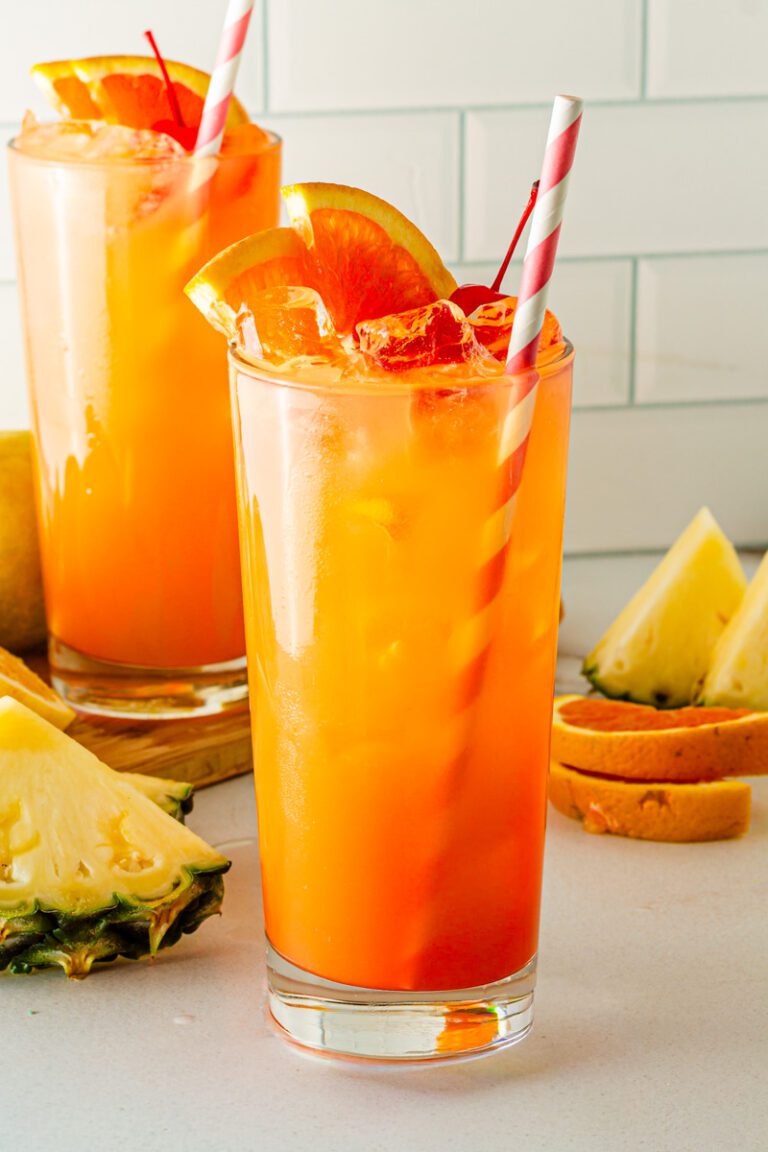 glass of cinderella mocktail with red and white straw
