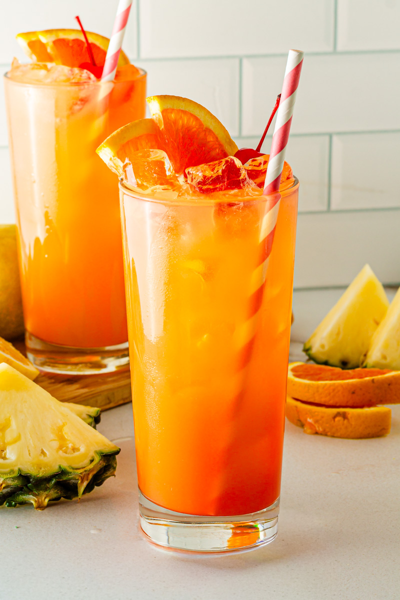 glass of cinderella mocktail with red and white straw