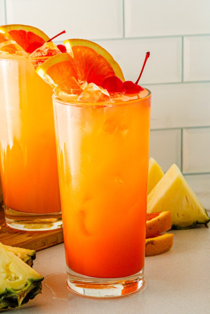 Garnishing Cinderella Mocktail with oranges 