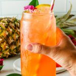 hand holding pineapple mocktail
