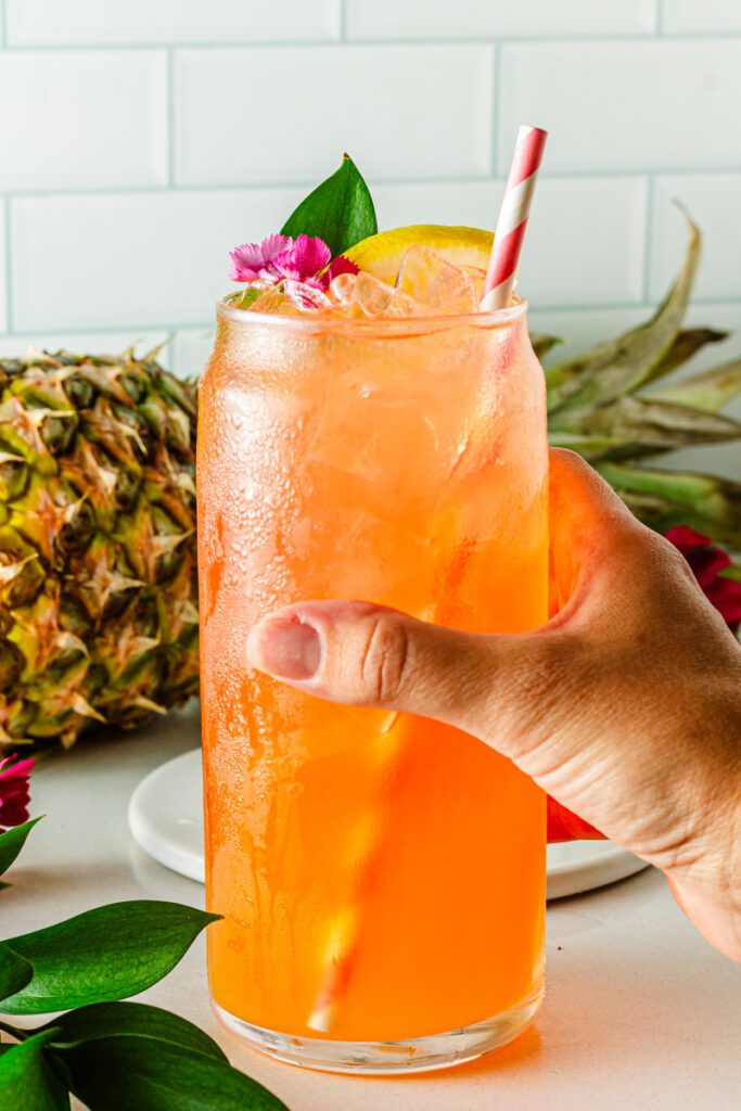 hand holding pineapple mocktail