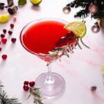 non-alcoholic gin mocktail bright red color with holiday greens